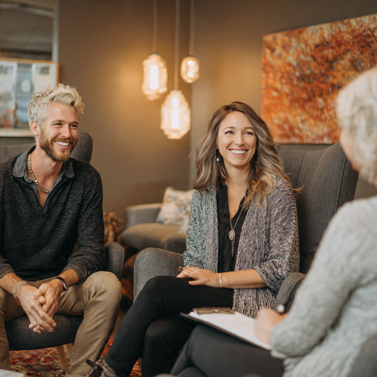 a marriage and family therapist working with clients in a warm office setting
